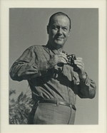 Portrait Photograph of Ross Macdonald Holding Binoculars